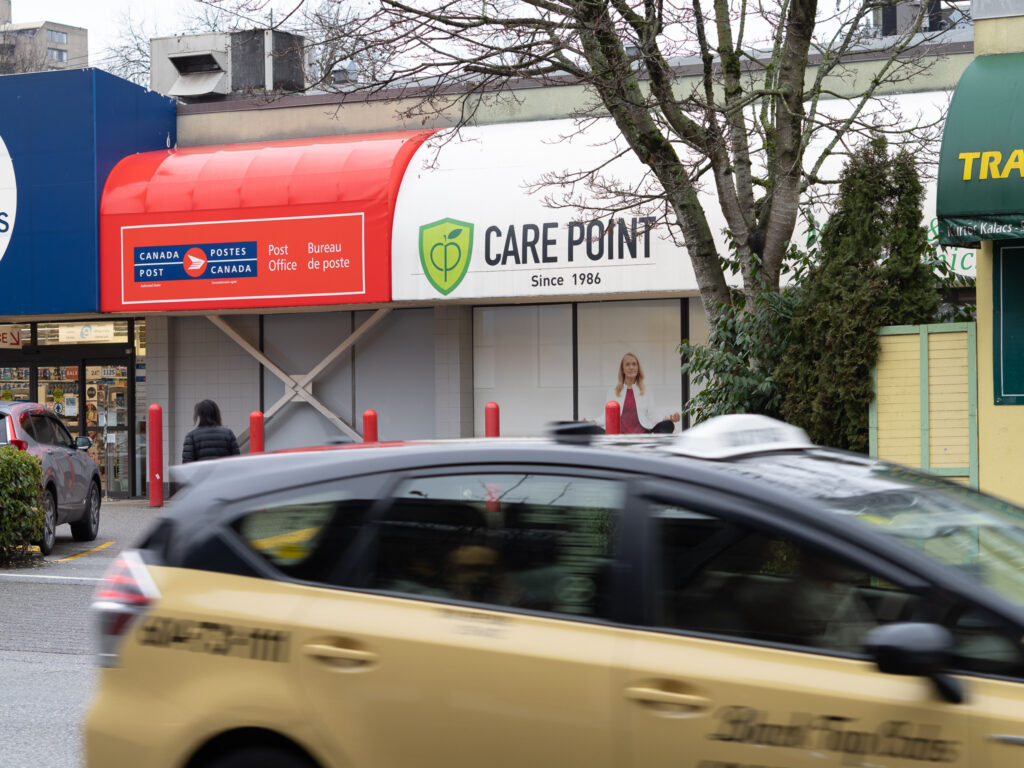 A taxi drives by the Care Point Clinic on Davie Street in Vancouver's West End Neighbourhood.